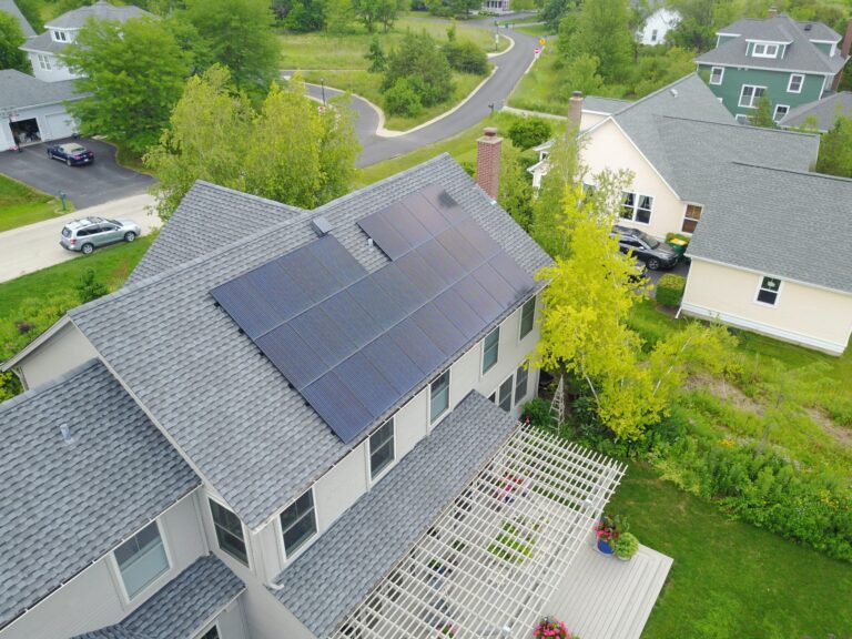 aerial view of a set of solar panels installed on the roof of a house.
